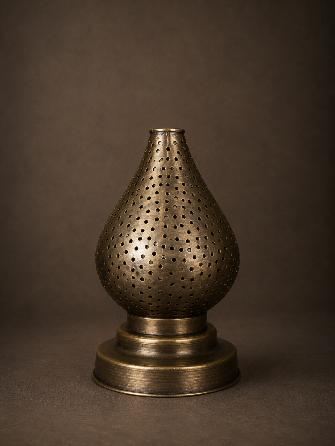 Handcrafted Brass Candle Holder with Teardrop Shape and Round Perforations